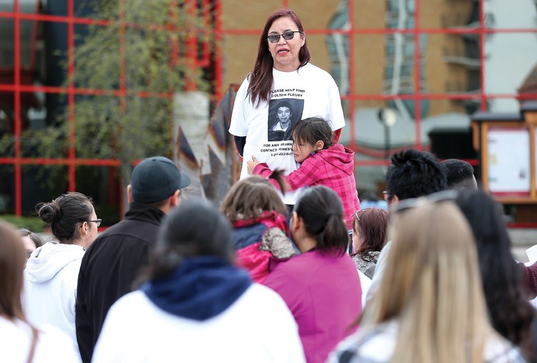 Phyllis Fleury speaks prior to a walk to raise awareness of the disappearance of her son, Colten, a year ago.