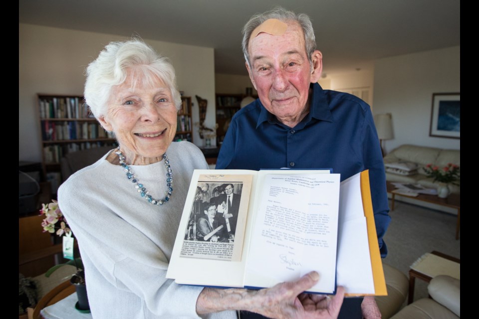 Werner and Inge Israel with a book and letter from physicist Stephen Hawking that were almost lost.