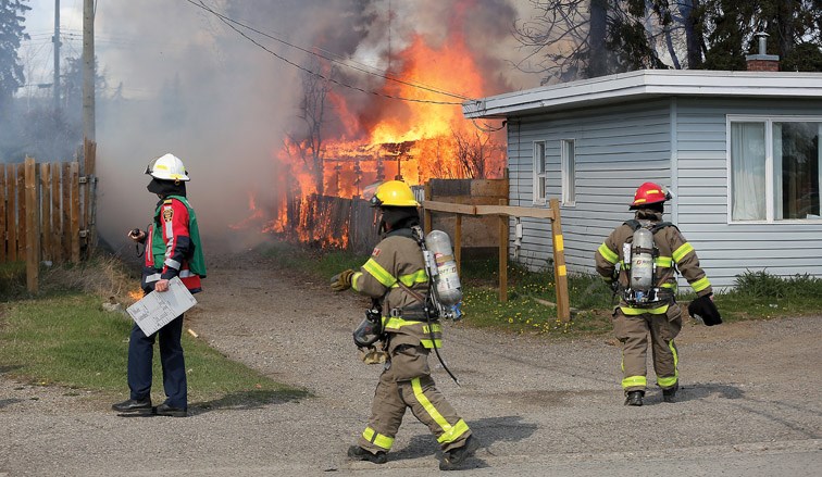 Fire crews plan their attack on a structure fire on the 2100-block of Spruce Street on Sunday morning. Citizen Photo by James Doyle
