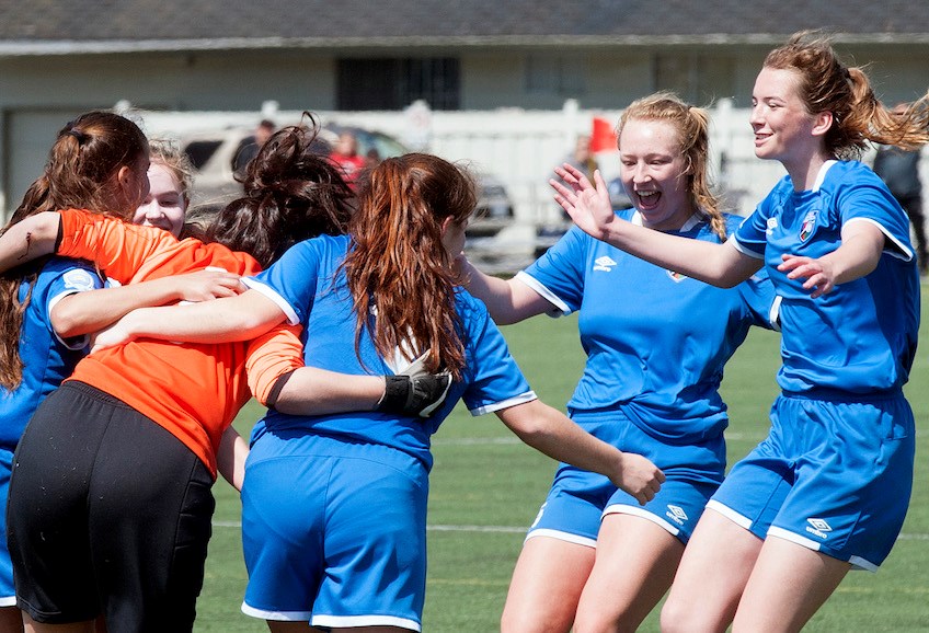 Delta Coastal Selects goalkeeper Nastia Khotiaintseva Lopez is mobbed by her teammates moments after the final whistle in Sunday's 2-1 Coastal "A" Cup final win over North Shore at Richmond's Minoru Park. The girls rep team is now off to provincials in July.