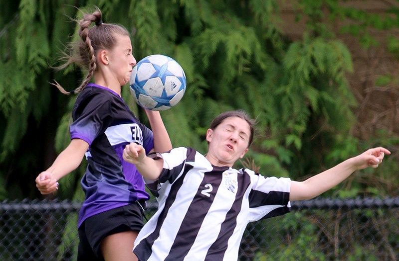 MARIO BARTEL/THE TRI-CITY NEWS Dr. Charles Best Blue Devils midfielder Jenna Mele clashes with an Elgin Park defender in their opening round match of the Fraser Valley high school senior girls soccer championships, Monday at Best. The Blue Devils won the match, 3-0, to advance to a quarter-final match Wednesday (after The Tri-City News' deadline) against the Centennial Centaurs, who defeated W.J. Mouat 10-0. The Riverside Rapids also advanced by defeating Abbotsford secondary 3-0. Heritage Woods lost its match to second-seed Fleetwood Park, 3-1.