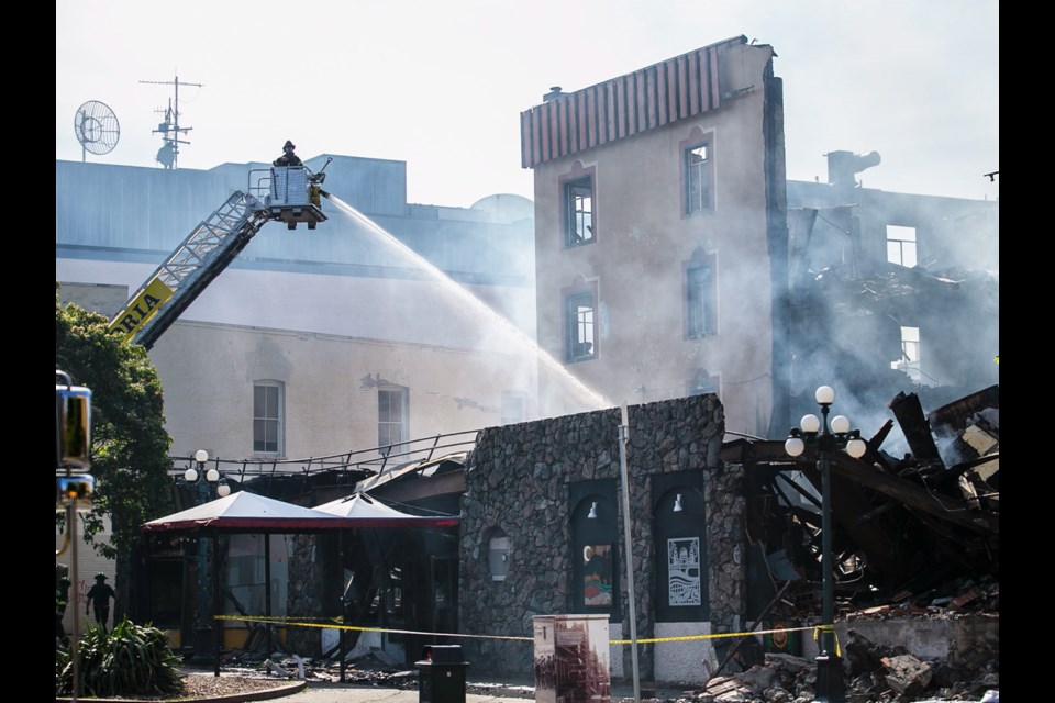 Firefighters continue to extinguish hot spots in the remains of the former Plaza Hotel and Monty&rsquo;s strip club on Tuesday.