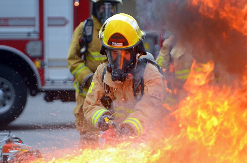 Byrne Creek Grade 12 student Nathan Ly battles a blaze during the Burnaby Fire Department’s youth academy last Thursday.