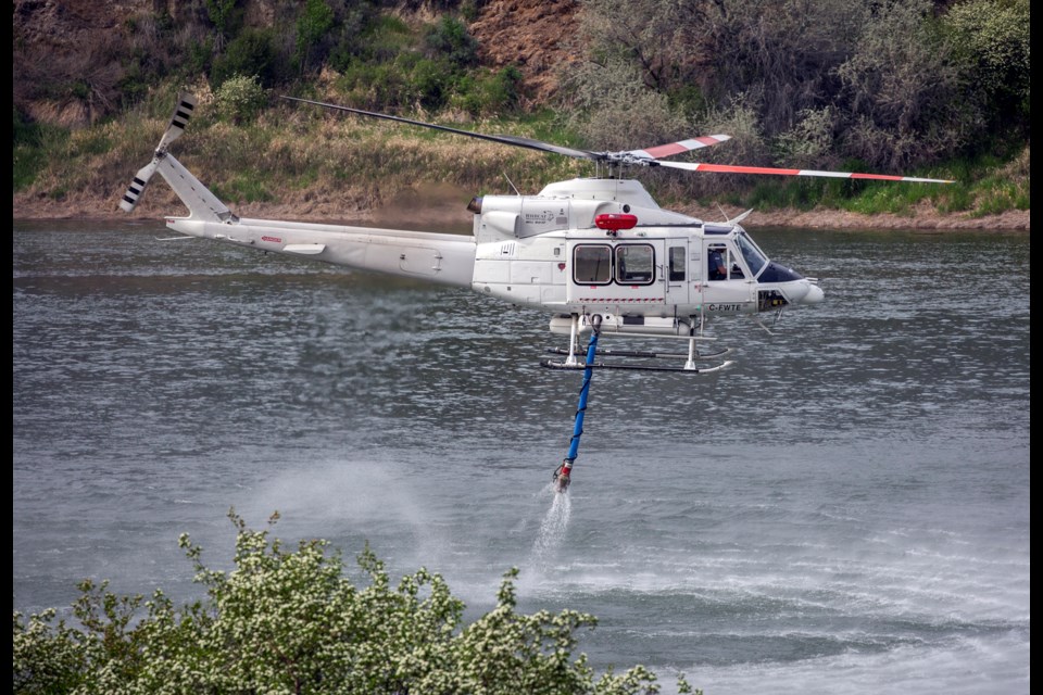 A helicopter gathers water from the South Thompson River to use on the Buse Creek fire east of Kamloops.