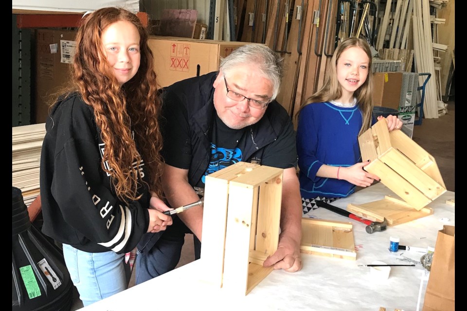 Master Carver Simon James gives Ailee and Maeve a lesson in how to work with wood and nails.