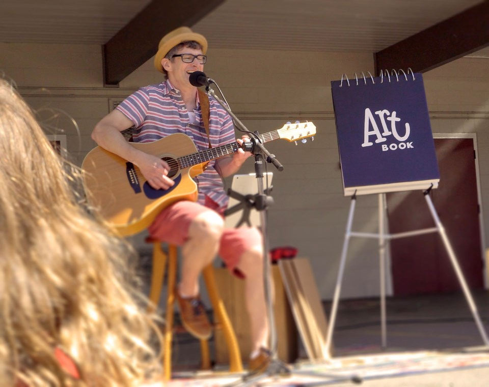 Inspired by Mr. Dressup, Mike Bryden combines drawing with music in his children's performances.