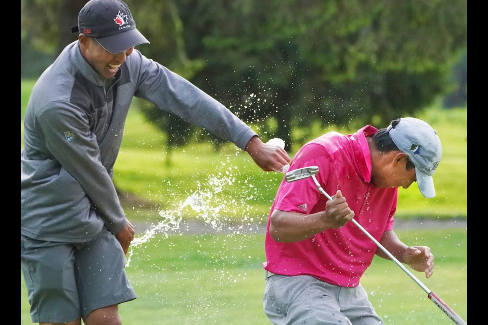 Michael Crisologo gets a victory shower from his older brother Chris after winning Golf Canada's Future Links Acura Pacific Championship in a playoff.