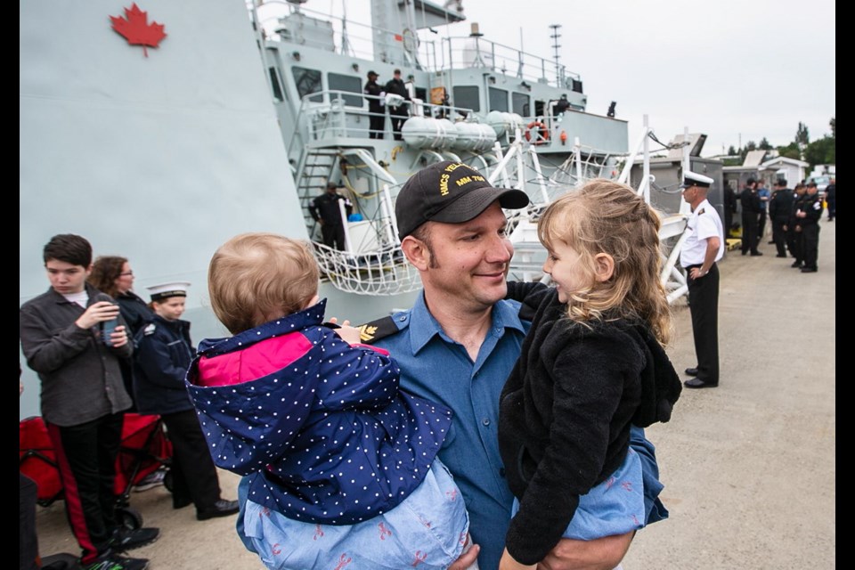 HMCS Yellowknife Master Seaman Mark Chase holds his daughters 18-month-old Holly Chase and three-year-old Alice Chase and after arriving at CFB Esquimalt on Thursday, May 16, 2019.