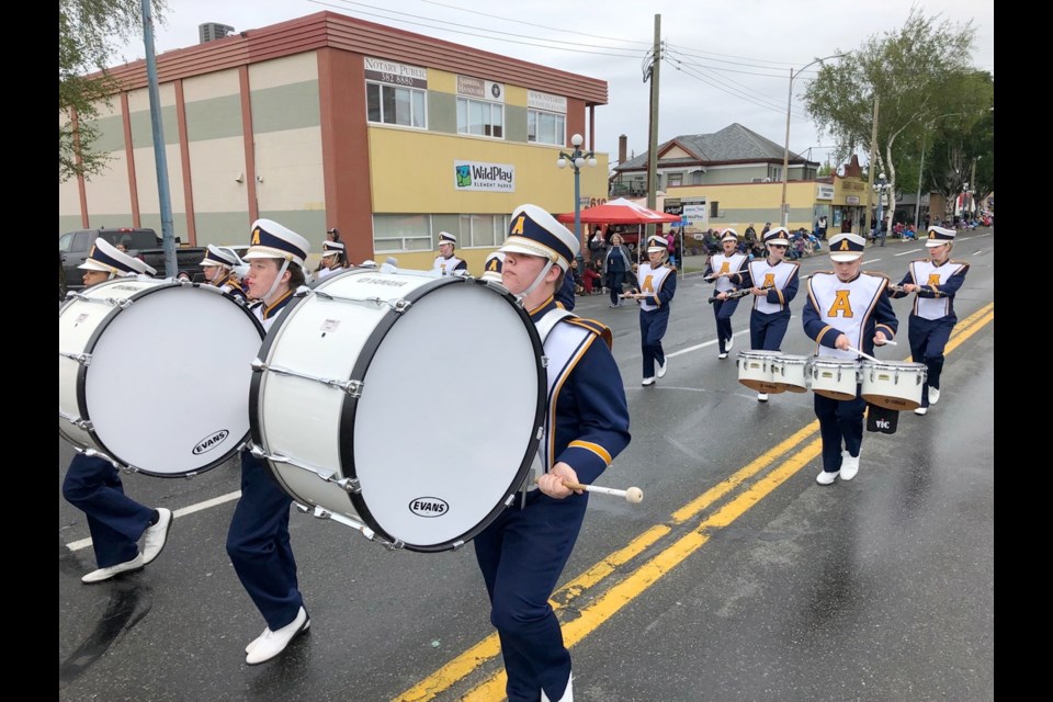 A marching band makes its way down Douglas Street during the Island Farms Victoria Day parade on Monday.