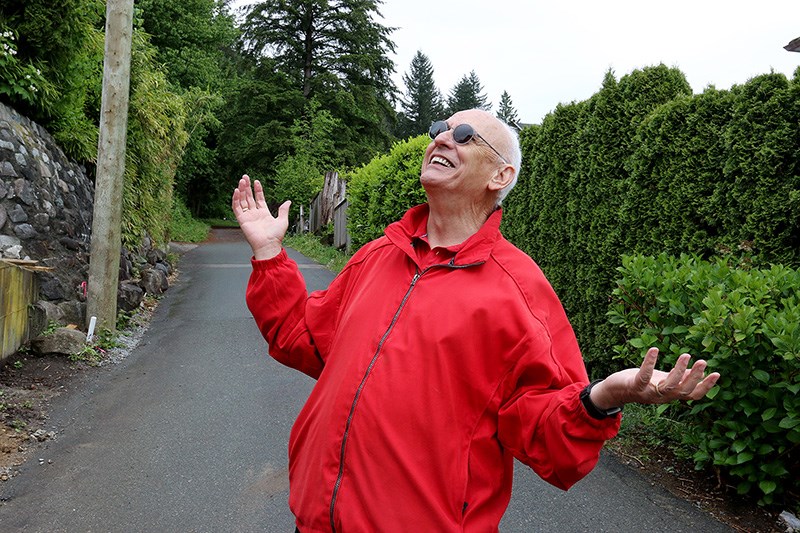 MARIO BARTEL/THE TRI-CITY NEWS Former Port Moody mayor and alderman David Driscoll, looks skyward towards his late friend, Bill McCracken, who passed away last year at the age of 96. Driscoll successfully pitched city council to endorse changing the name of Miner Lane, where he's standing, to McCracken Lane in honour of the contributions he and his family made to building community in the Pleasantside neighbourhood.