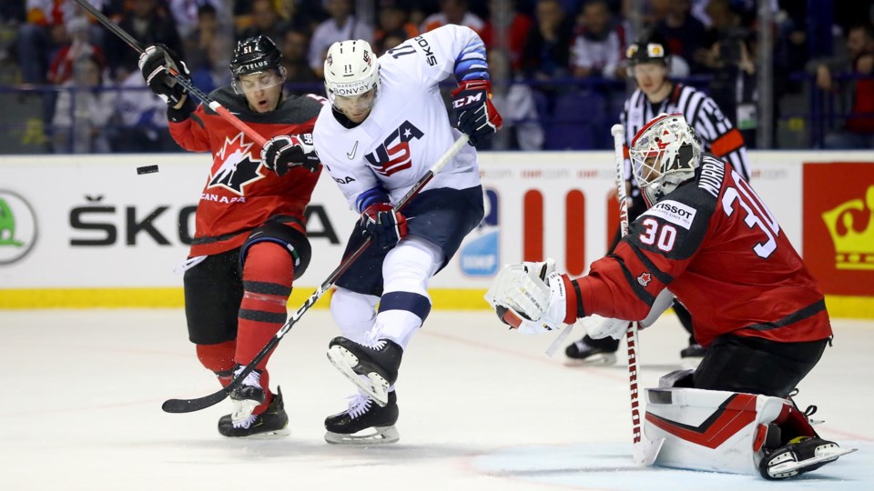 Troy Stecher battles in front of the net for Team Canada