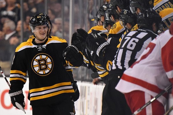 Torey Krug celebrates a goal at the Boston Bruins bench.