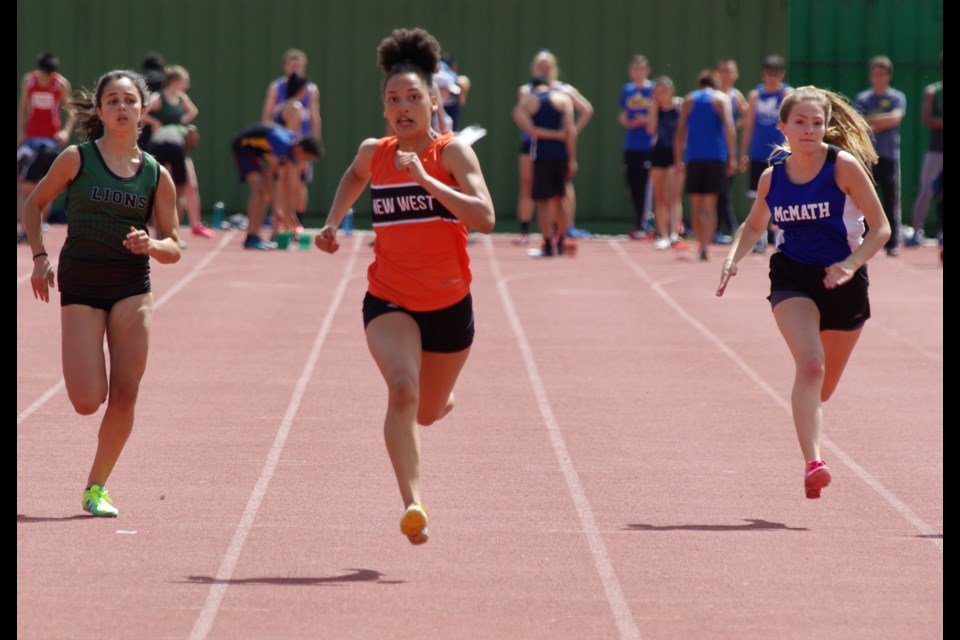 New West's Anja Tjernagel leads the pack during the junior girls 100m final at the zone championships.