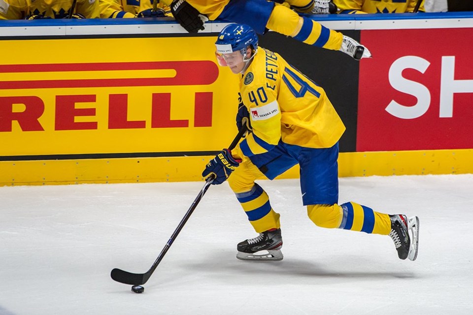 Elias Pettersson skates with the puck for Sweden.