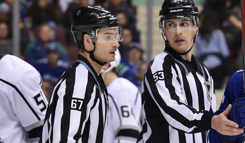 Linesmen Travis Gawryletz and Bevan Mills decide on a call.