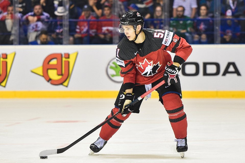 Troy Stecher carries the puck for Team Canada.