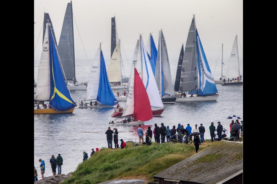 Spectators watch the start of the Swiftsure International Yacht Race on Saturday.