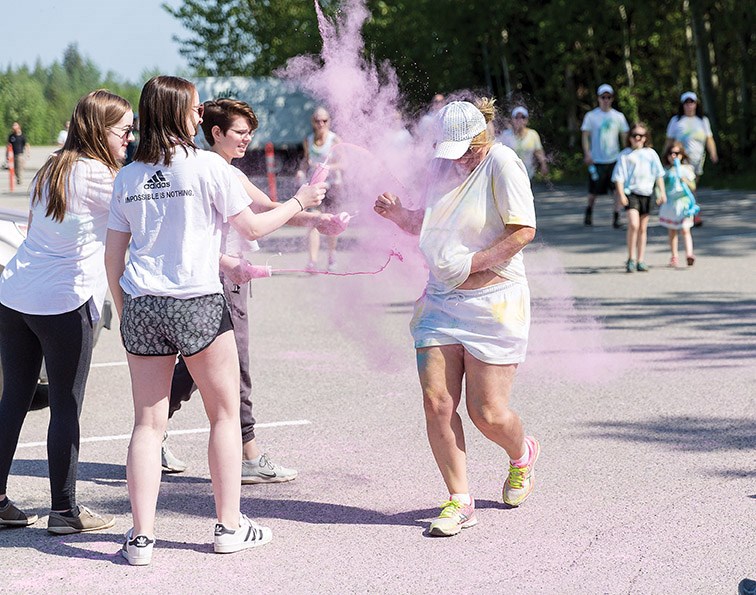 Red colour is thrown at a walker on Sunday morning during the first annual Prince George Hospice Society Colour Walk at UNBC. Citizen Photo by James Doyle