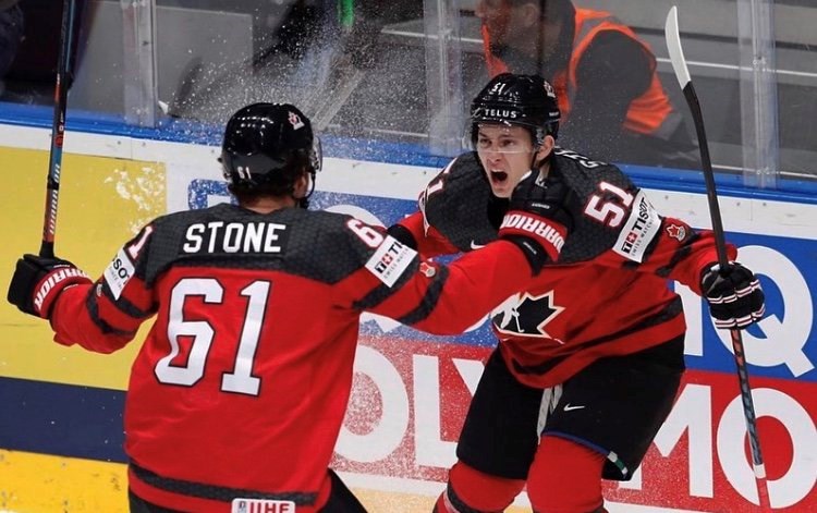 Troy Stecher celebrates a goal with Mark Stone for Team Canada.