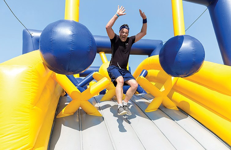 Tony Wyssen leaps off the final obstacle on Saturday morning during the first annual Mega Bounce Run. Citizen Photo by James Doyle