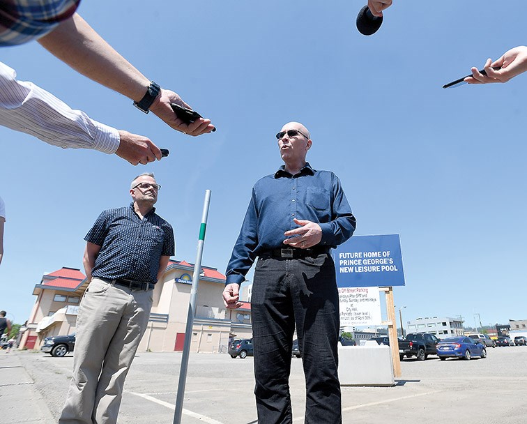 Mark Hentze of CEI Architecture Associates Inc. speaks to local media Thursday about initial plans for a new leisure pool downtown while Dominic Ries of Chandos, a construction management firm, looks on.