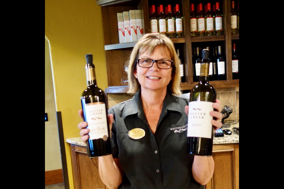 Wine Shop Manager Jacqueline Davidson and two of Hester Creek’s finest reds. Photo: Eric Hanson