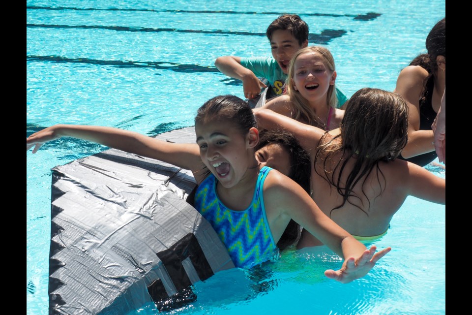 Students from Parkland elementary in Coquitlam built boats out of cardboard and tape Friday, putting their engineering skills to the test at Spani pool. Here, one team competes in the weight challenge.