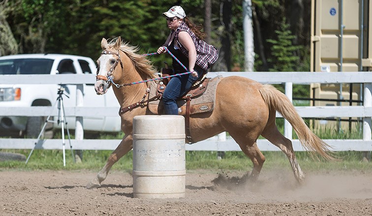 Stephanie Serwatkewich barrel races around Pineview Riding Arena on Sunday morning during the Pineview Community Gymkhana that was hosted by the Timberline Riders Gymkhana Club. Citizen Photo by James Doyle