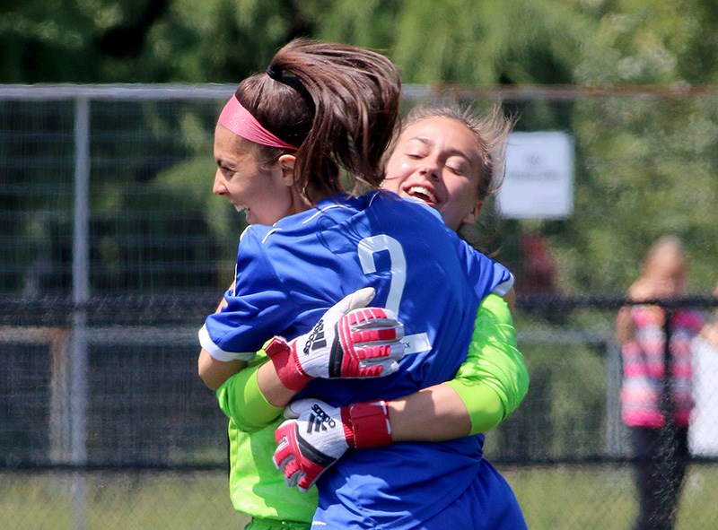 MARIO BARTEL/THE TRI-CITY NEWS Centennial Centaurs Lucia Zecca celebrates with keeper Kelsey Eckert after the team won its second consecutive BC High School AAA senior girls soccer championship, 2-1 in overtime, against the Fleetwood Park Dragons, Friday at the Cloverdale Athletic Park in Surrey.