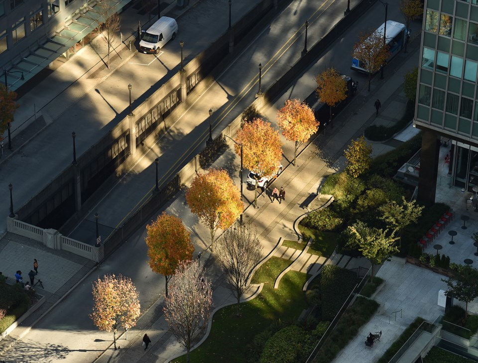 A view with afternoon sunlight shining between downtown buildings. Photo Dan Toulgoet