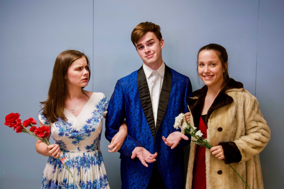 Arrogant businessman Nero Sharpe, played by Charlie O’Connor, centre, dies suddenly after eating a meal at Luigi’s Italian restaurant in Who Poisoned His Meatball?, a dinner theatre production by New Westminster Secondary School drama students. Emily Kleamyck, left, portrays Nero’s wife Flora Sharpe and Alia Homenuke plays his mistress Arlene D’Amore.