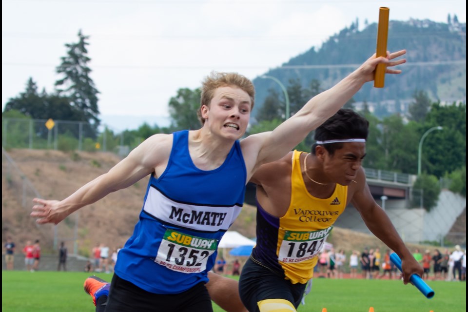 McMath's Carson Bradley completes a thrilling anchor leg by stretching out to edge Vancouver College at the finish line and capture the senior boys 4x100 relay at the B.C. Secondary Schools Track and Field Championships in Kelowna.