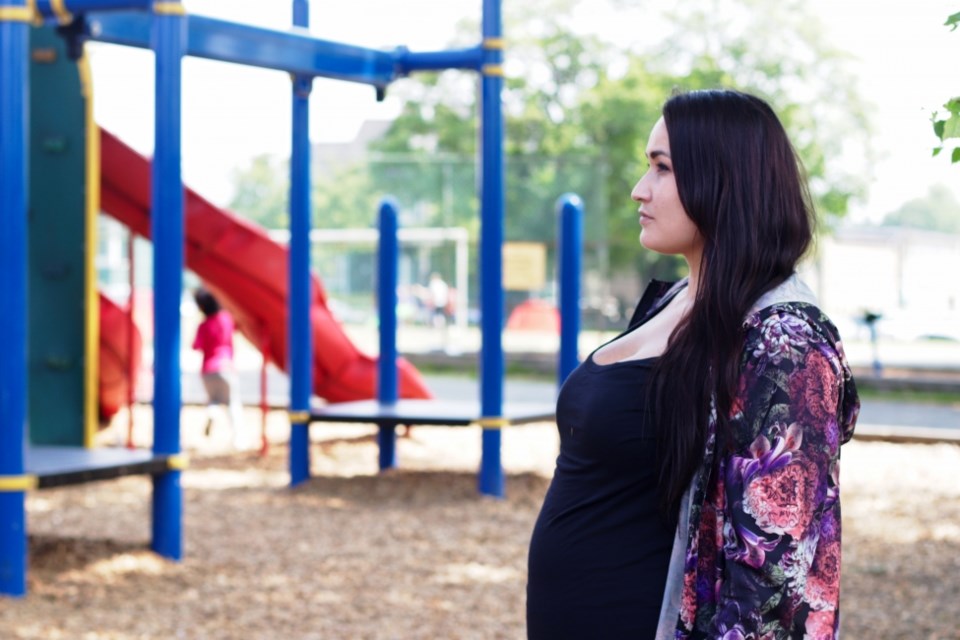 A pregnant Ronda Merrill-Parkin watches her kids — who were removed by the government in 2018 and re