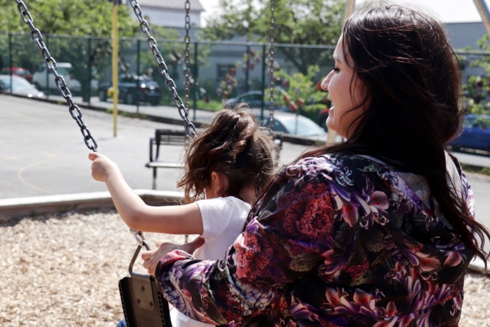 Ronda Merrill-Parkin plays with her daughter in a Vancouver schoolyard. Brielle Morgan/The Discourse