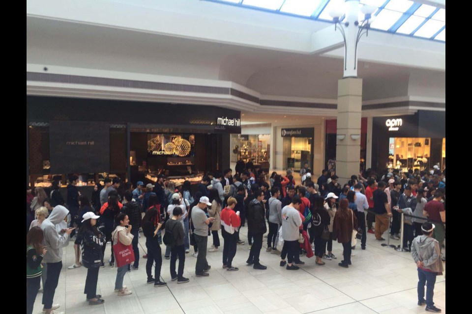 Hundreds of people lined up for hours in Richmond Centre to get their hands on a designer T-shirt at Uniqlo. Nono Shen photos