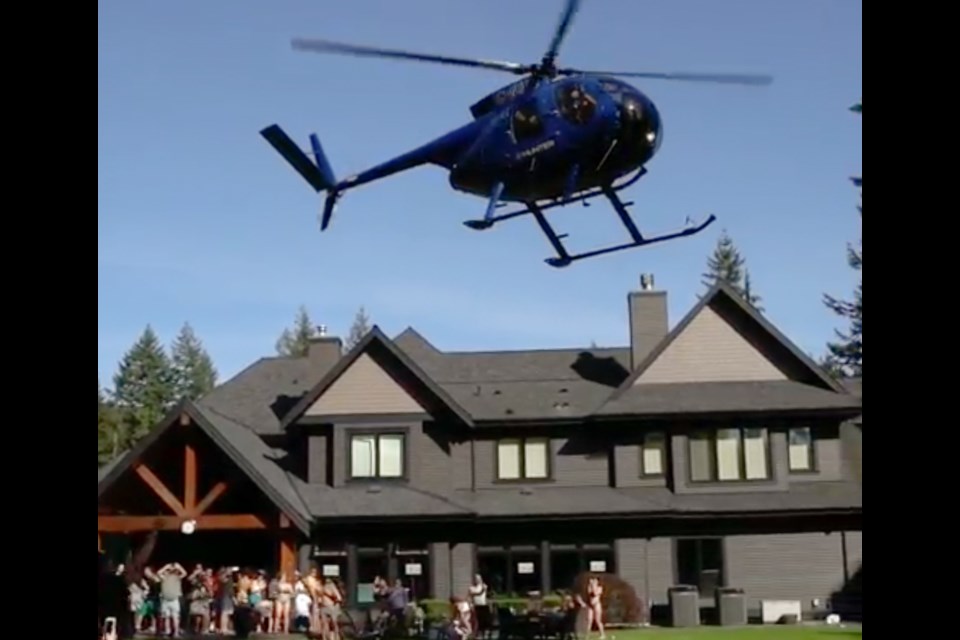 A helicopter lands at the party in Anmore