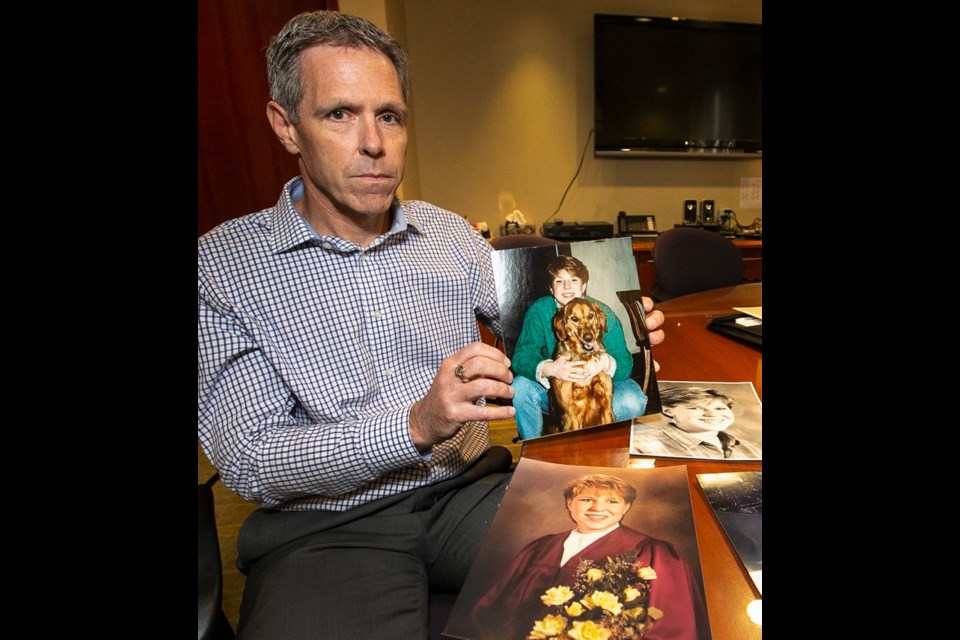 John van Cuylenborg with photos of his sister Tanya Van Cuylenborg.