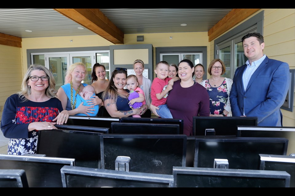 VICTORIA, B.C.: June, 6, 2019 - Saanich South MLA Lana Popham (L) and Andrew Wesolowski (R) with Electronic Recycling Association have teamed up to donate 27 refurbished computers to Rosalie