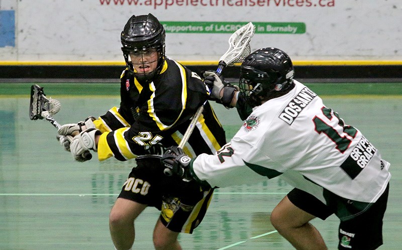 MARIO BARTEL/THE TRI-CITY NEWS PoCo Saints runner Jacob Dunbar tries to get around Burnaby Lakers defender Nicholas Dos Santos in the first period of their BC Junior A Lacrosse League game, Monday at Copeland Arena in Burnaby. The Lakers won, 12-7.