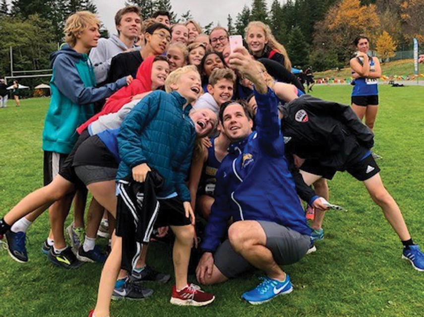 Ryne Melcher grabs a selfie with some members of his track team. Melcher will run 250 laps of the Handsworth track this Friday, a feat which should take about 12 hours. photo supplied