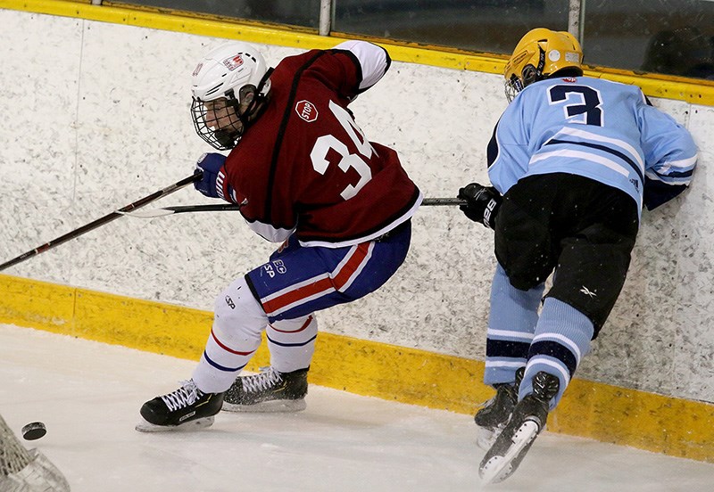 Heritage Woods Kodiaks forward Ryan Tattle, left, scored the first shootout goal in the team's 5-4 win over the Sardis Falcons to win the BC High School Hockey League championship, that was played recently in Delta.