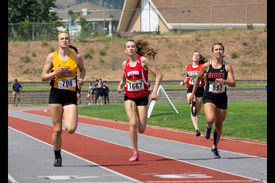 Carrying over the gold feeling from the multi-event meet two weeks ago, St. Thomas More's Kate Stewart-Barnett, at centre, captured a provincial title in the junior girls 1500m steeplechase, as well as silver in the 400m race and with the 4x400m relay team.