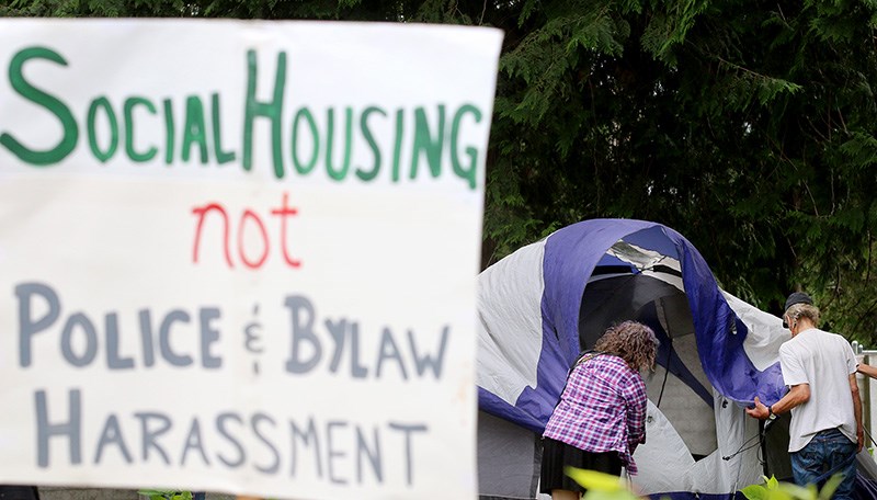 Homelessness advocates begin erecting an encampment next to the 3030 Gordon shelter in Port Coquitlam Thursday afternoon.