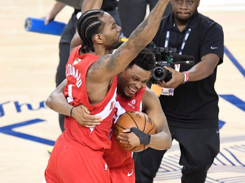 Toronto Raptors forward Kawhi Leonard (2) and Toronto Raptors guard Kyle Lowry (7) celebrate defeating the Golden State Warriors in Game 6 of the NBA Finals in Oakland, California, on Thursday, June 13, 2019. Organizers of the Olympic qualifying tournament in Victoria are installing the floor the team won on in hopes it proves lucky to Team Canada. THE CANADIAN PRESS/Frank Gunn