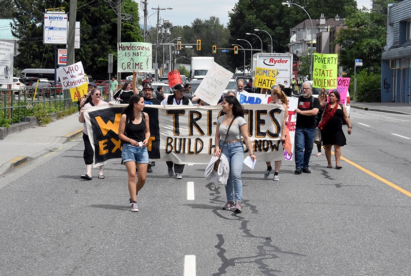Demonstrators walked down Kingsway Avenue Thursday on route to 3030 Gordon Ave., where they attempted to setup a tent city.