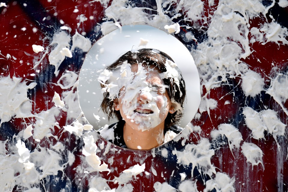 He's got game: Jeremy Mendoza took one in the face at Bellies Day festivities in Queen's Park. A pie-throwing contest was part of the day's fun.