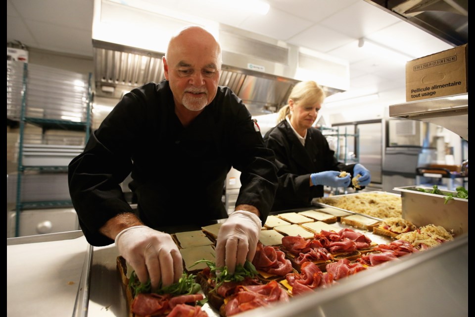 Chef Allan Daly and Sandy Poulin make sandwiches at Ravensview. June 2019
