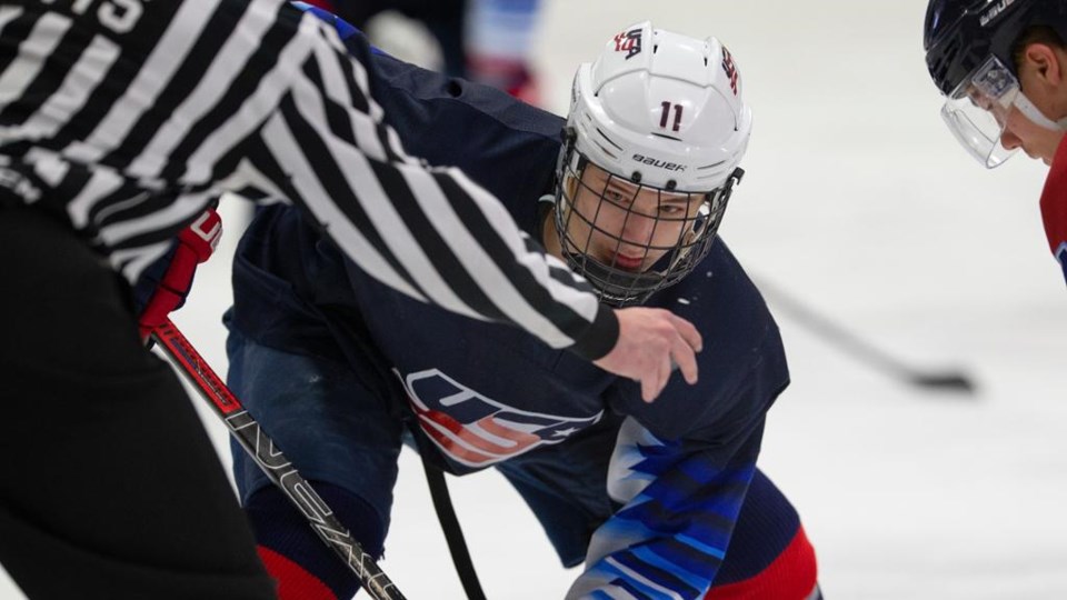 Trevor Zegras takes a faceoff for the US National Team Development Program.