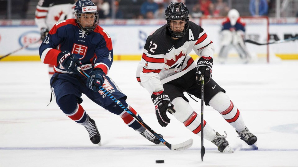 Dylan Cozens drives wide for Canada.