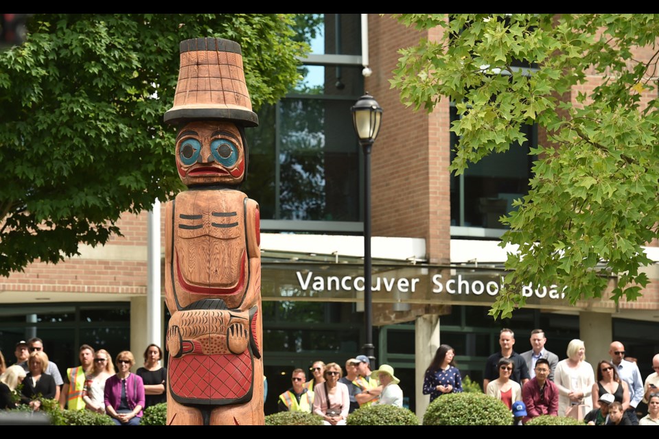 Students, school district staff and First Nations representatives convened at the Vancouver School Board office Friday for the unveiling of three massive welcome posts carved by members of the Squamish and Musqueam First Nations. Photo Dan Toulgoet